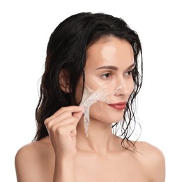 Photo of Beautiful woman peeling off face mask on white background