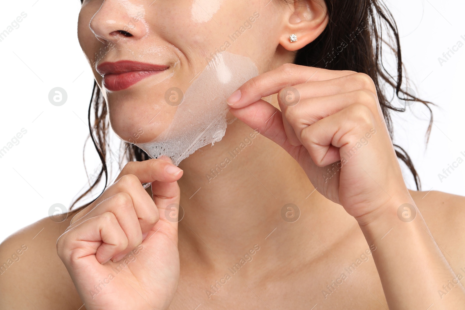 Photo of Woman peeling off face mask on white background, closeup