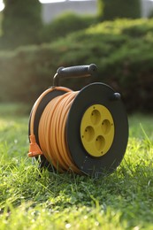 One extension cord reel on green grass outdoors