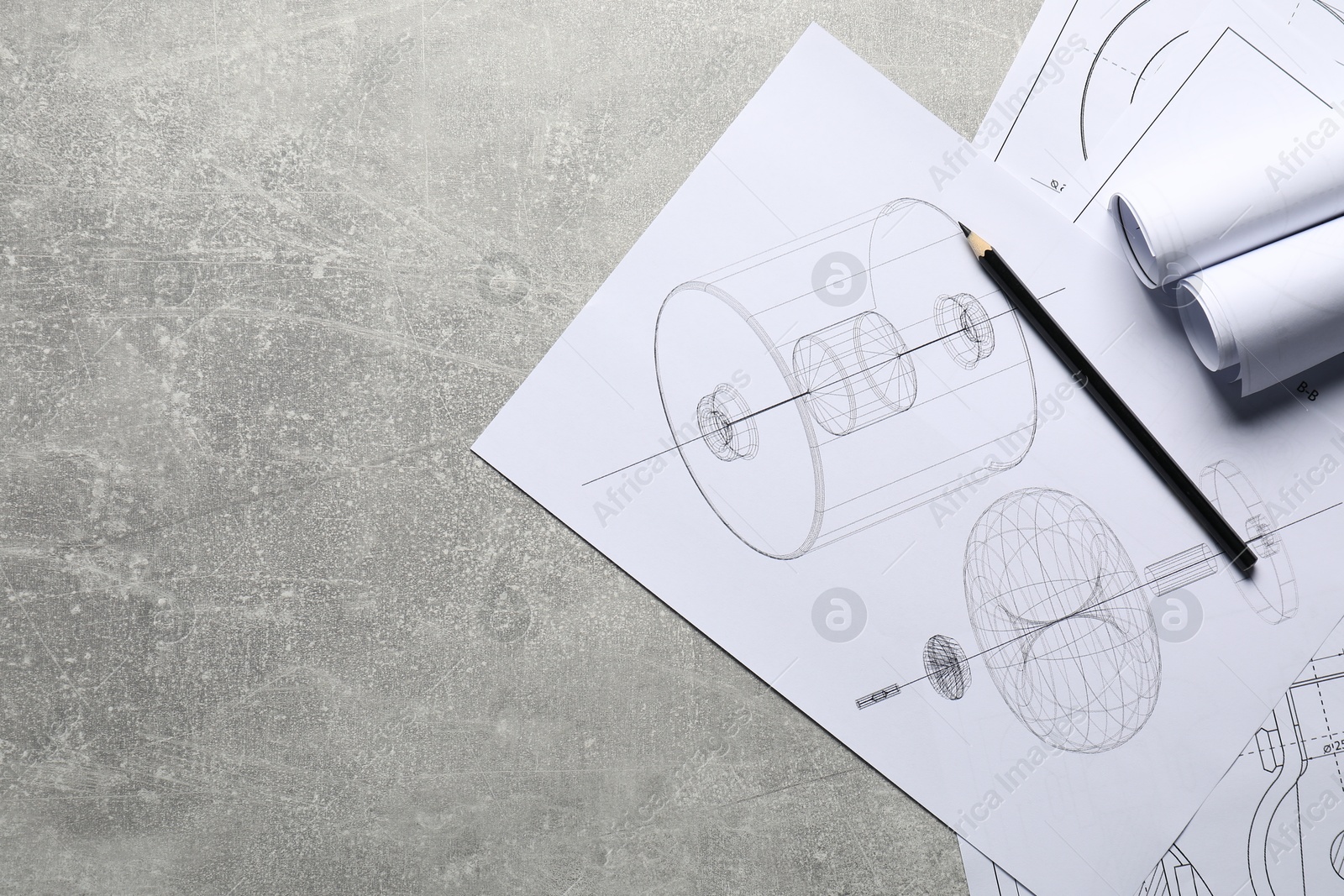 Photo of Different engineering drawings and pencil on gray textured table, top view. Space for text