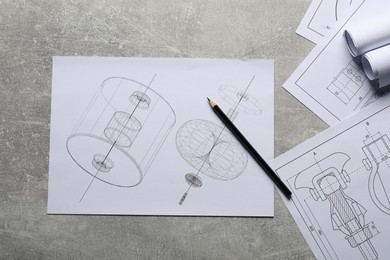 Different engineering drawings and pencil on gray textured table, top view