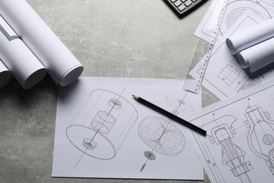 Different engineering drawings and tools on gray textured table, flat lay