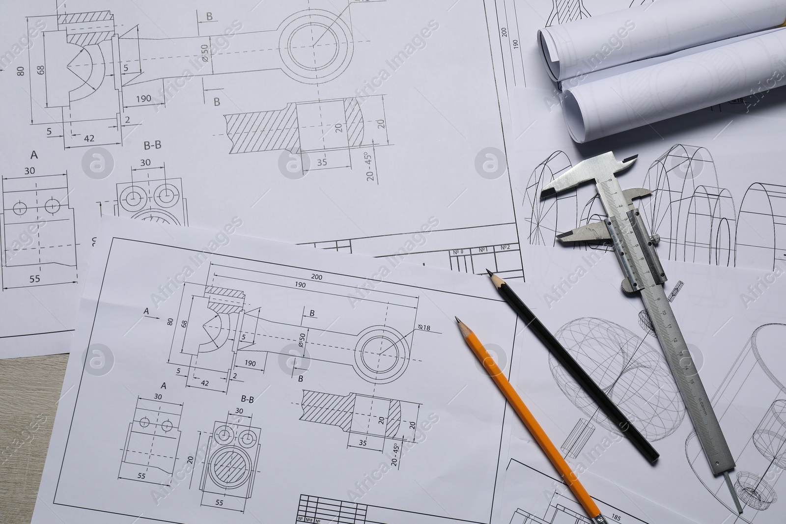 Photo of Different engineering drawings, vernier caliper and pencils on table, top view