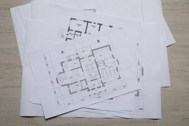 Photo of Different architectural drawings on wooden table, top view