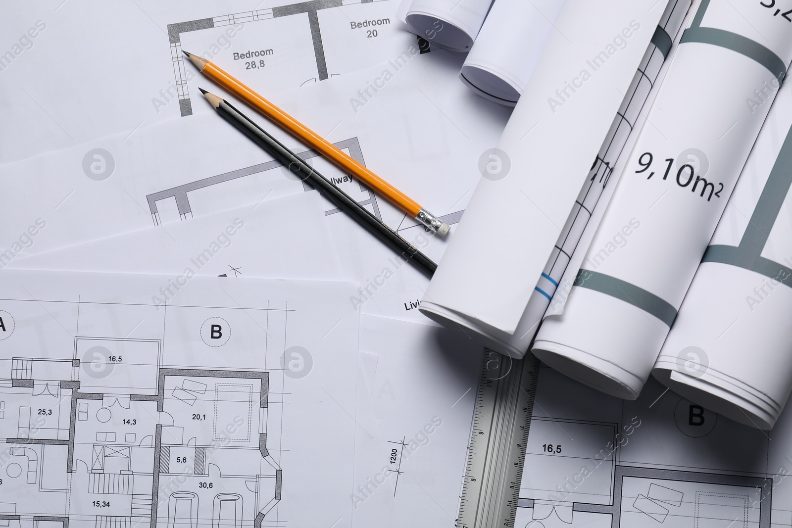 Photo of Different architectural drawings, ruler and pencils, top view