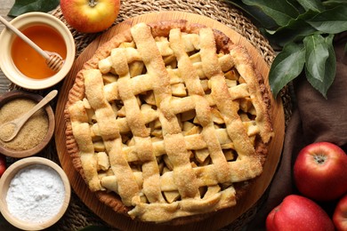 Flat lay composition with tasty homemade apple pie and ingredients on table