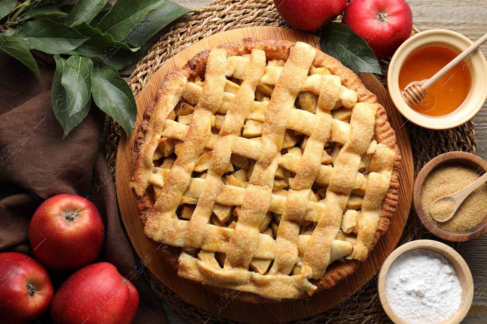 Photo of Flat lay composition with tasty homemade apple pie and ingredients on table