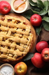 Flat lay composition with tasty homemade apple pie and ingredients on table