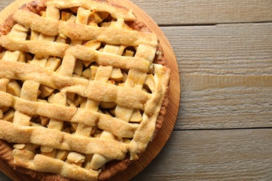 Tasty homemade apple pie on wooden table, top view. Space for text