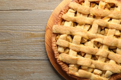 Tasty homemade apple pie on wooden table, top view. Space for text