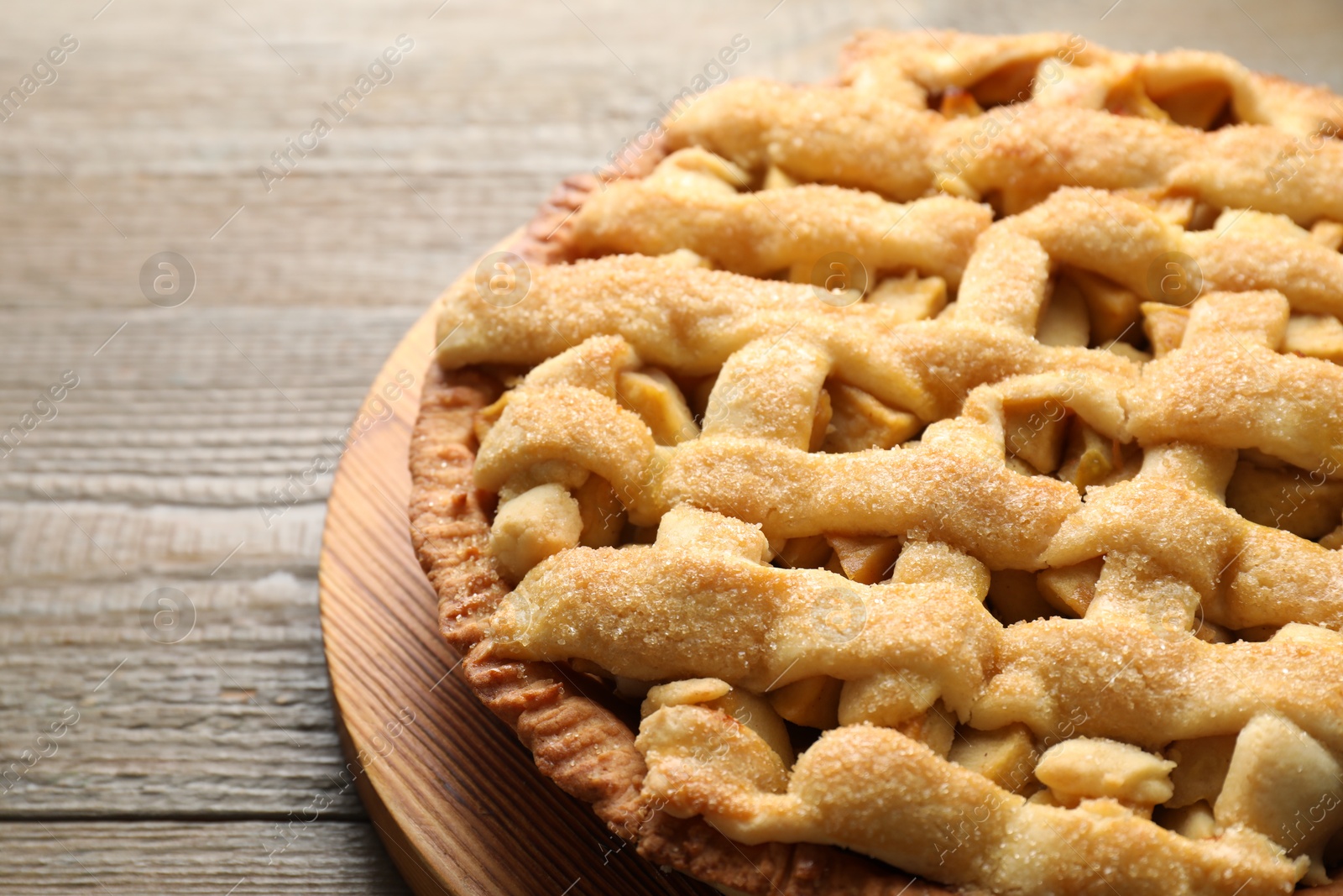 Photo of Tasty homemade apple pie on wooden table, closeup