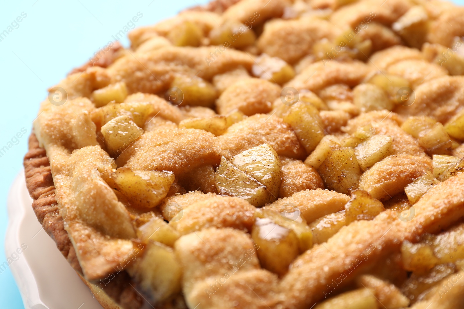 Photo of Tasty homemade apple pie on light background, closeup