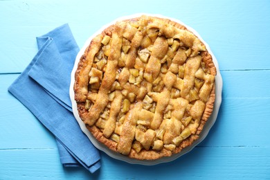 Homemade apple pie on light blue wooden table, top view