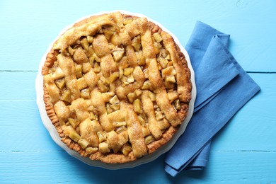 Photo of Homemade apple pie on light blue wooden table, top view