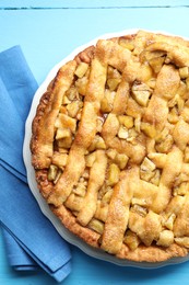 Homemade apple pie on light blue wooden table, top view