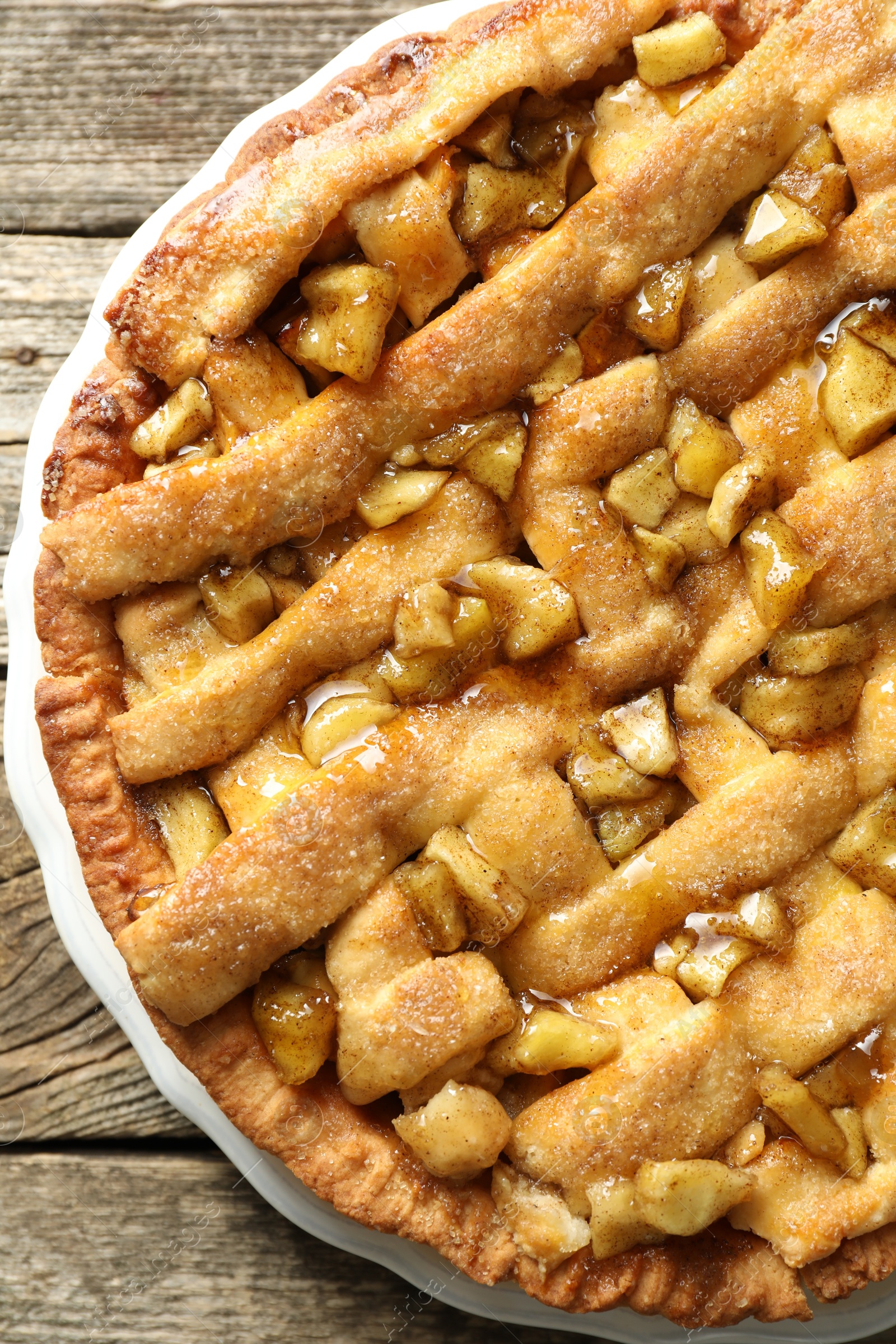 Photo of Homemade apple pie on wooden table, top view