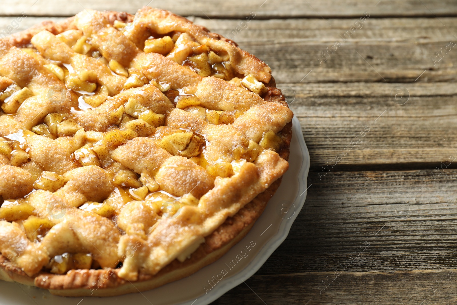 Photo of Homemade apple pie on wooden table, closeup