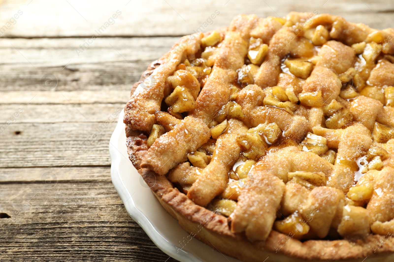 Photo of Homemade apple pie on wooden table, closeup