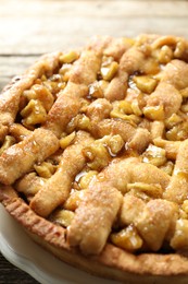 Photo of Homemade apple pie on wooden table, closeup