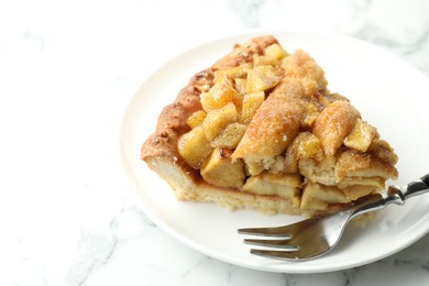 Photo of Slice of homemade apple pie and fork on white marble table. Space for text