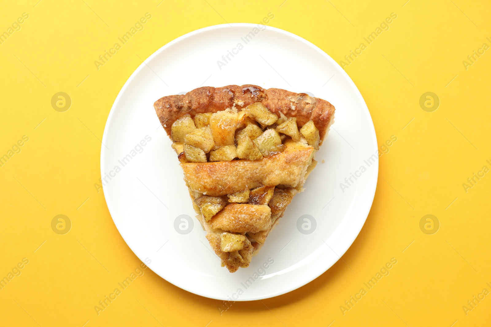 Photo of Slice of homemade apple pie on orange background, top view