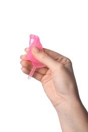 Photo of Woman folding pink menstrual cup on white background, closeup