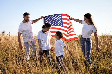 Happy family with flag of USA outdoors