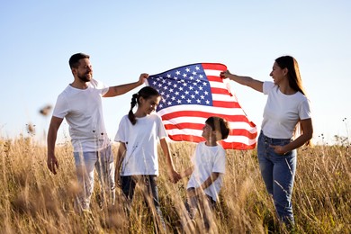 Happy family with flag of USA outdoors