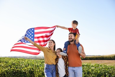 Happy family with flag of USA outdoors