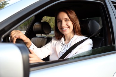 Photo of Woman holding steering wheel while driving car