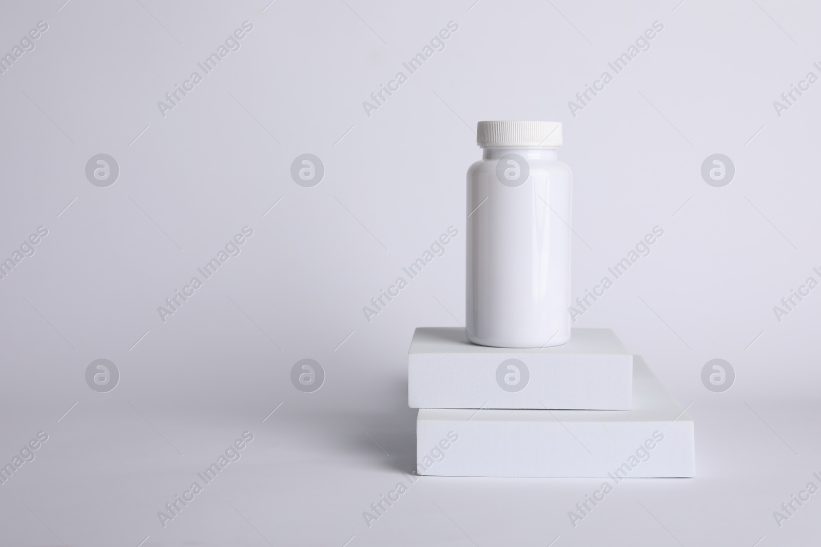 Photo of Plastic medical bottle on white background, space for text