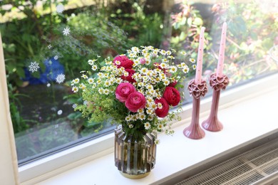 Photo of Beautiful ranunculus flowers and chamomiles in vase on windowsill indoors