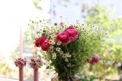 Photo of Beautiful ranunculus flowers and chamomiles near window indoors