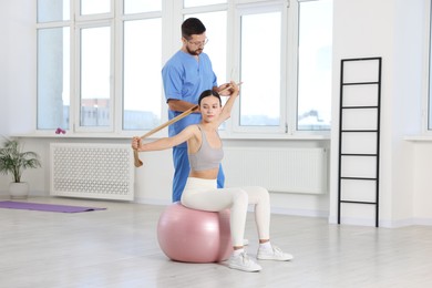 Photo of Patient exercising under physiotherapist supervision in rehabilitation center