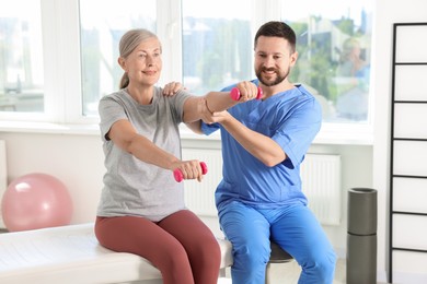 Senior patient exercising under physiotherapist supervision in rehabilitation center