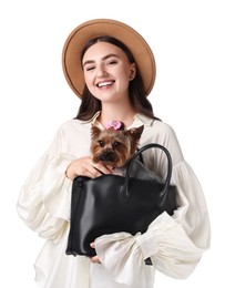 Beautiful young woman holding bag with cute Yorkshire Terrier dog isolated on white