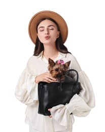 Beautiful young woman holding bag with cute Yorkshire Terrier dog isolated on white