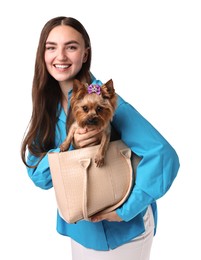 Beautiful young woman holding bag with cute Yorkshire Terrier dog isolated on white