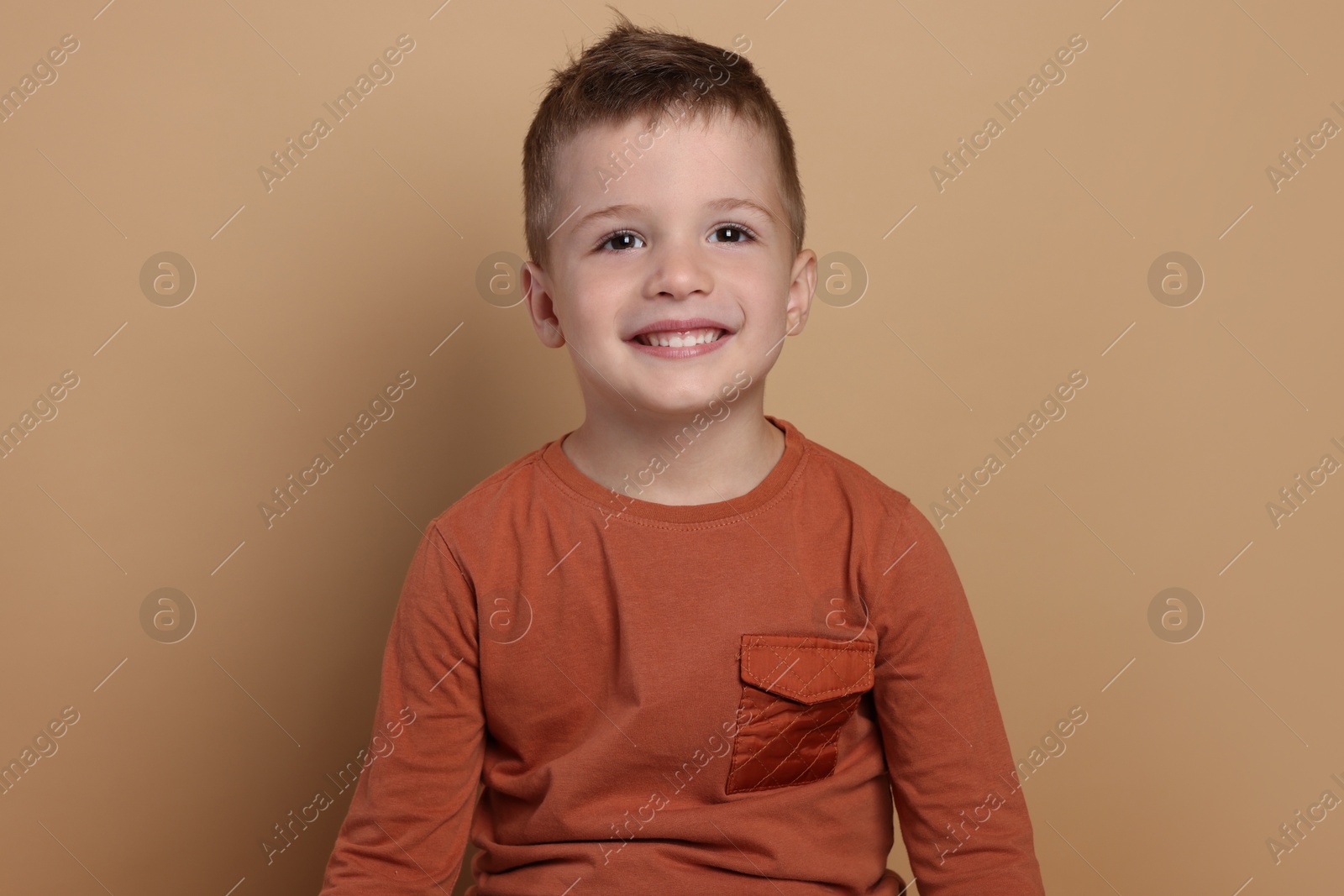 Photo of Portrait of cute little boy on pale background