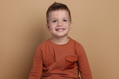 Photo of Portrait of cute little boy on pale background