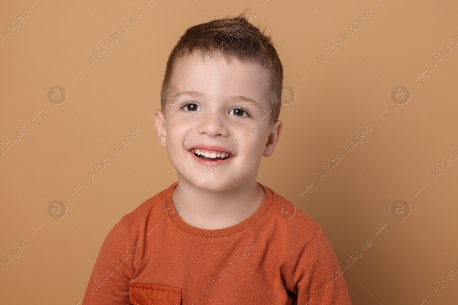 Photo of Portrait of cute little boy on pale background