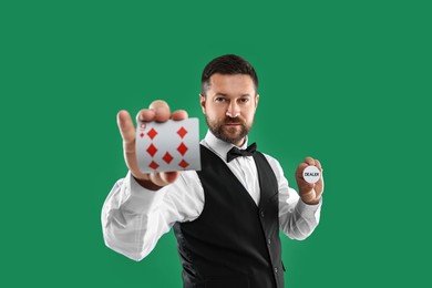 Photo of Croupier holding card and dealer button on green background