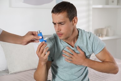 Man getting inhaler at home. Asthma treatment