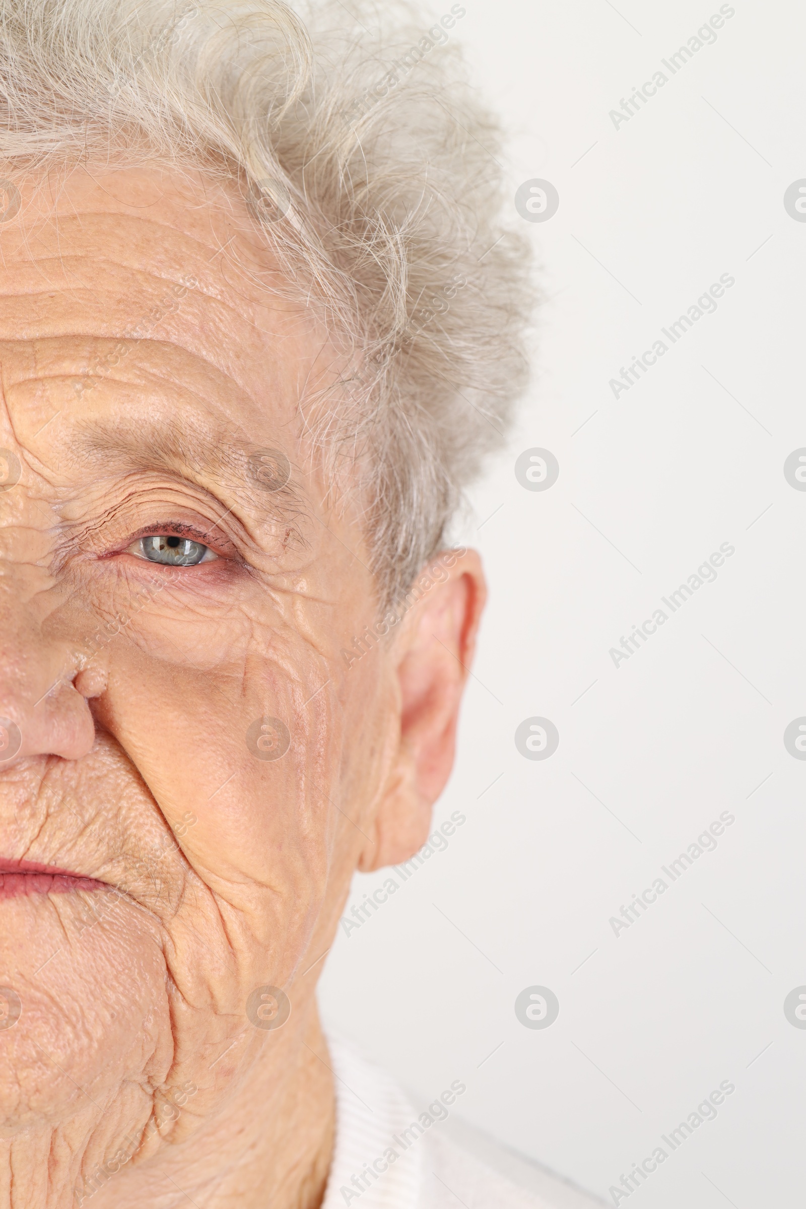 Photo of Senior woman with beautiful eyes on white background, closeup