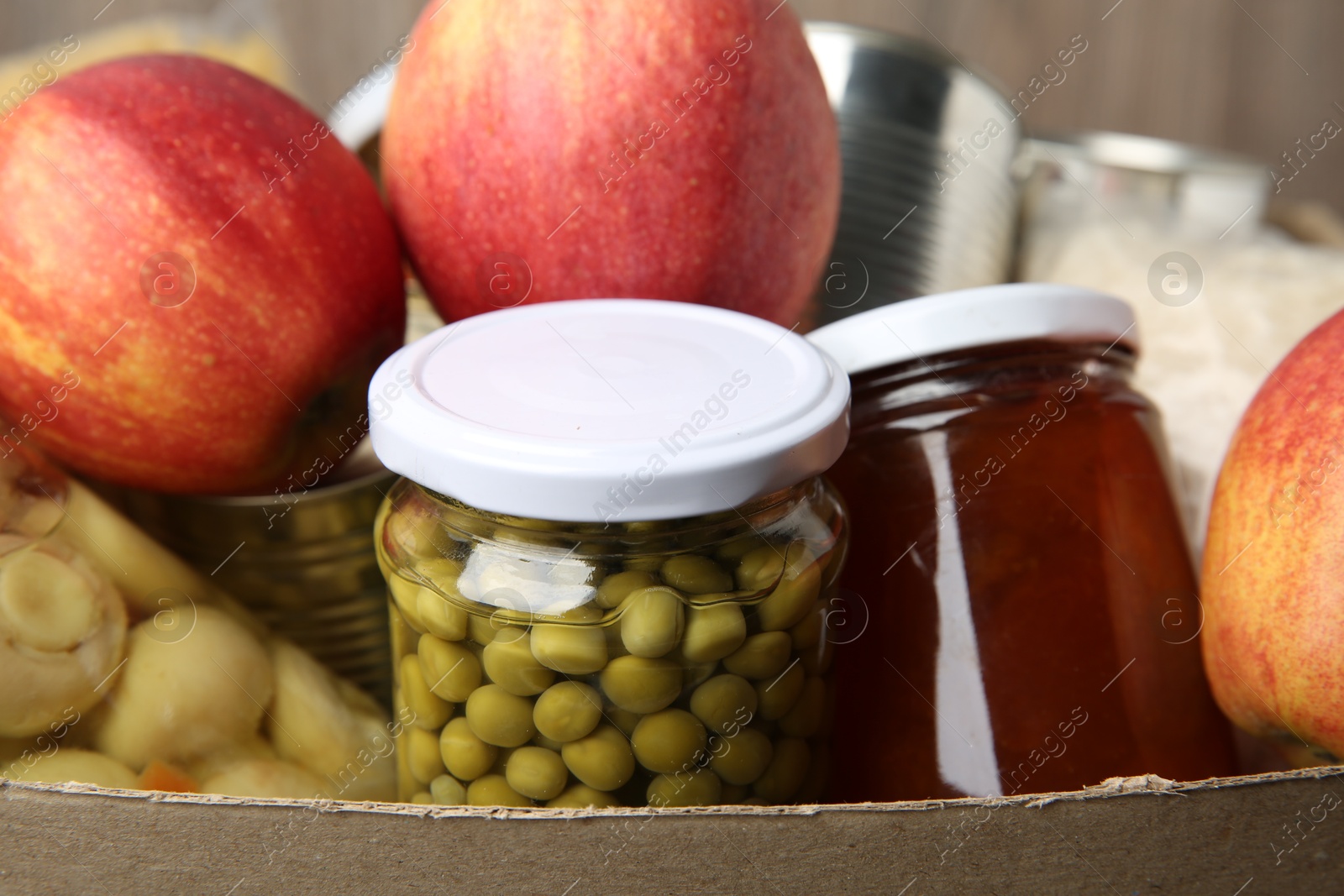 Photo of Different food products for donation in box, closeup