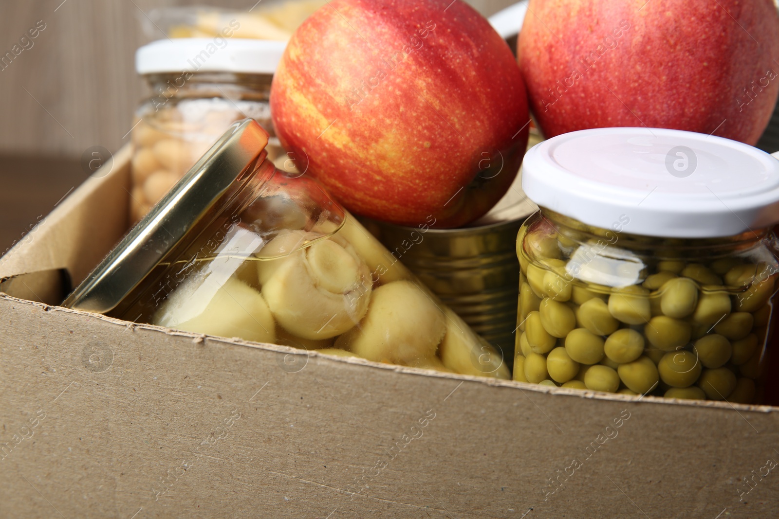 Photo of Different food products for donation in box, closeup