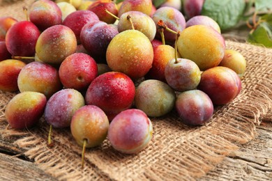 Photo of Pile of tasty ripe plums on table, closeup