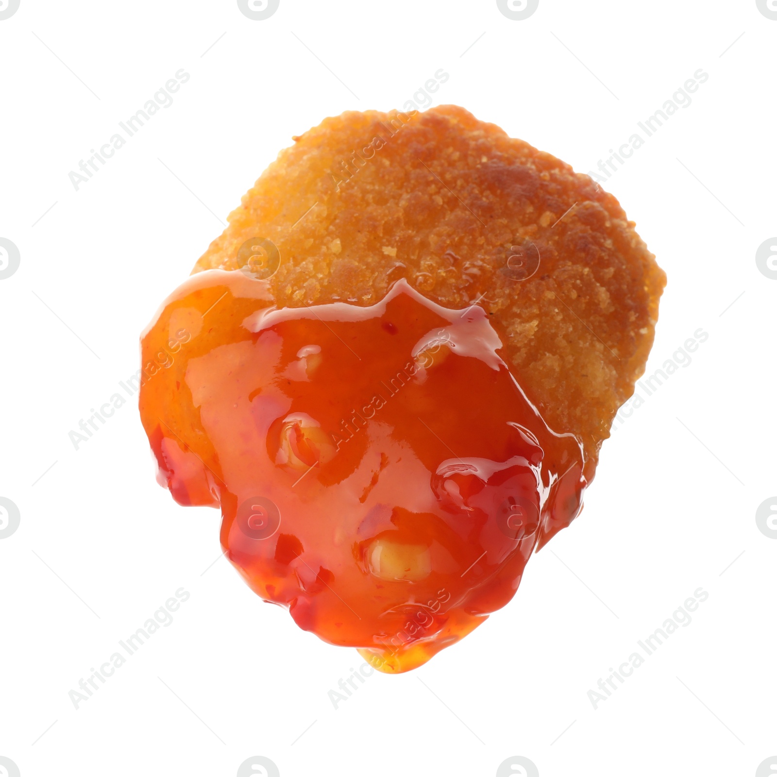 Photo of Tasty nugget dipped in hot chili sauce isolated on white