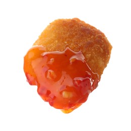 Photo of Tasty nugget dipped in hot chili sauce isolated on white