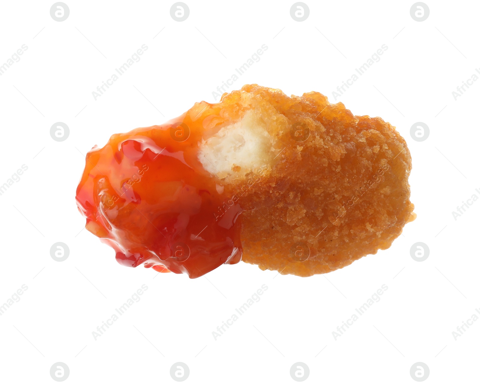 Photo of Tasty nugget dipped in hot chili sauce isolated on white